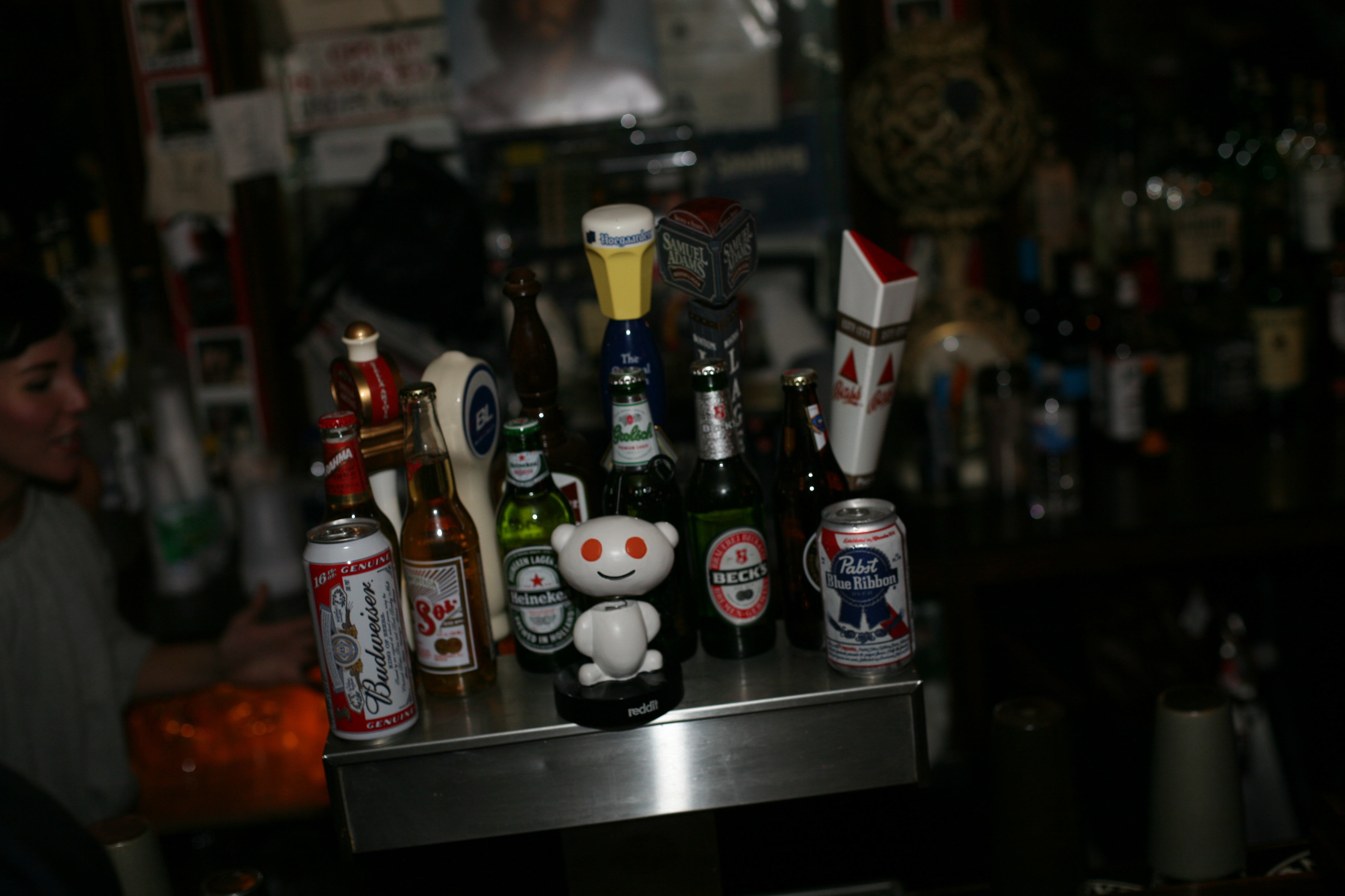 The Reddit alien bobblehead holding court among the beer bottles at the bar